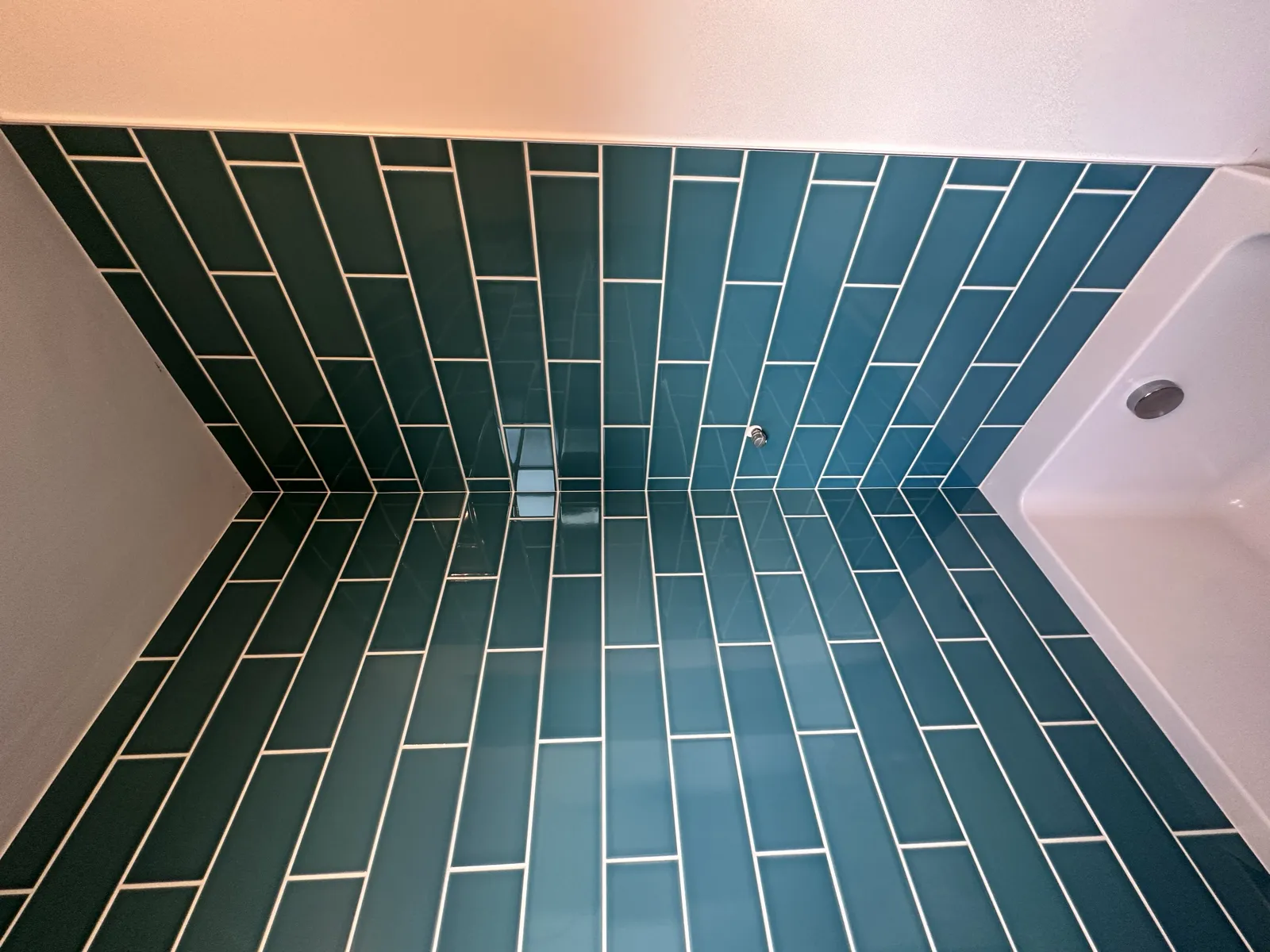 Green gloss tiled bathroom walls and floor