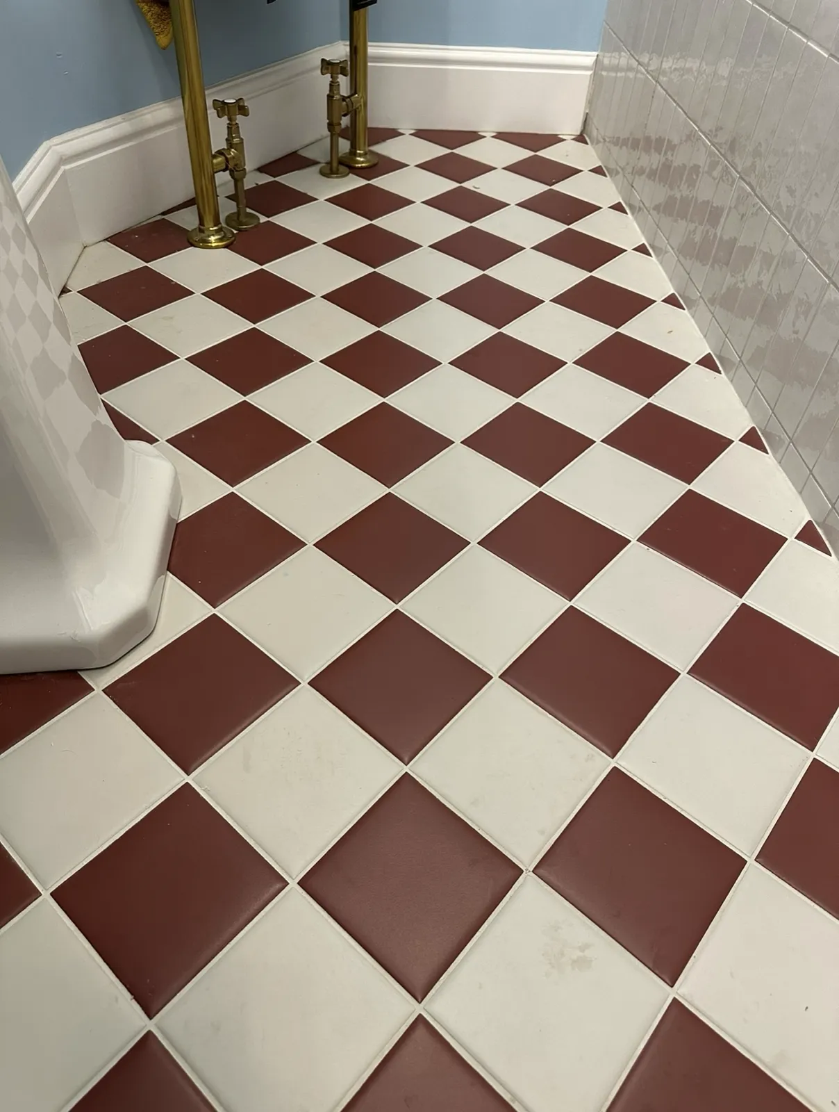 Red and white checkerboard tiled bathroom floor