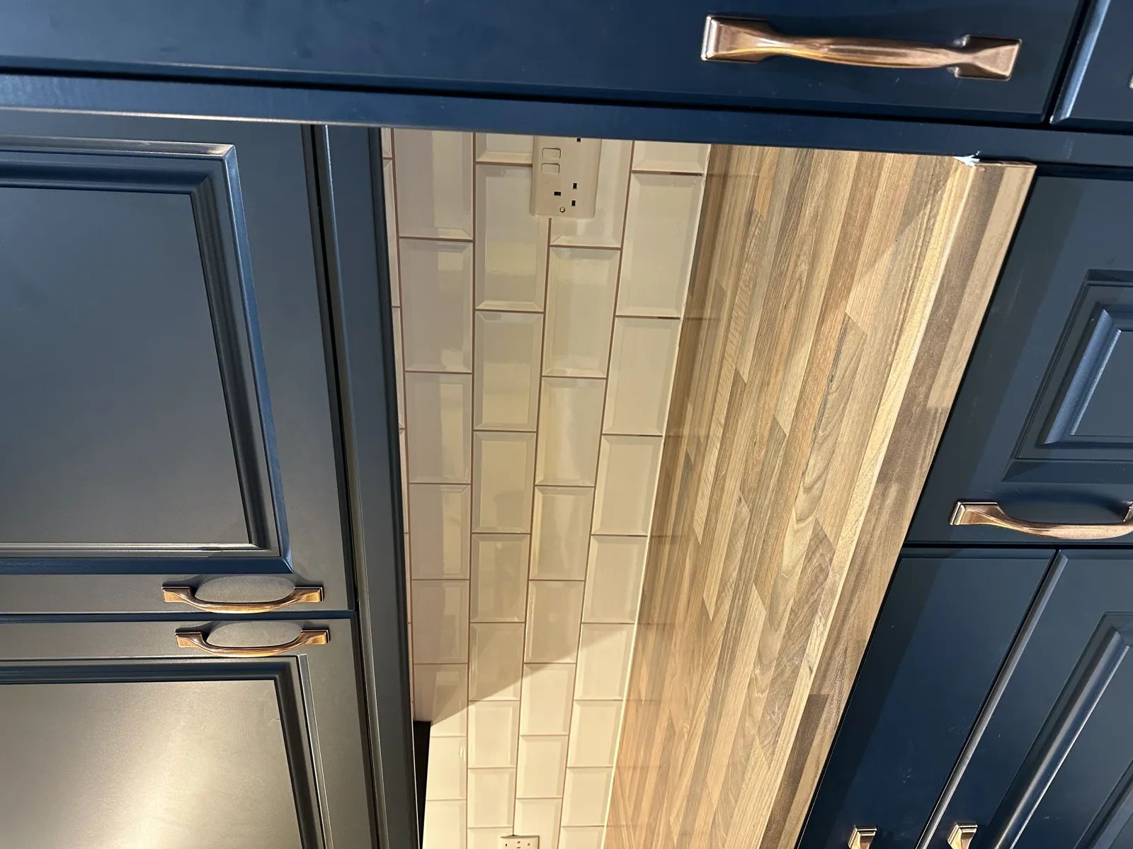 Navy kitchen with wood-effect tiled floor