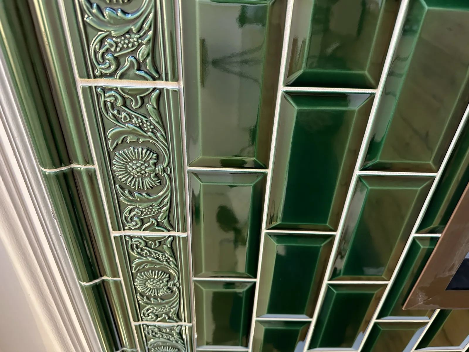 Heritage green gloss metro bathroom with ornate decorative border tiling by Luke Robinson Tiling, Norwich