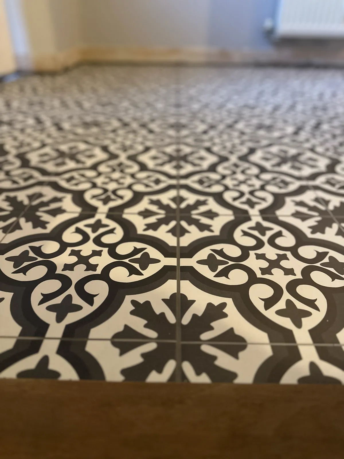 Monochrome Victorian-pattern bathroom floor tiles laid in Norwich
